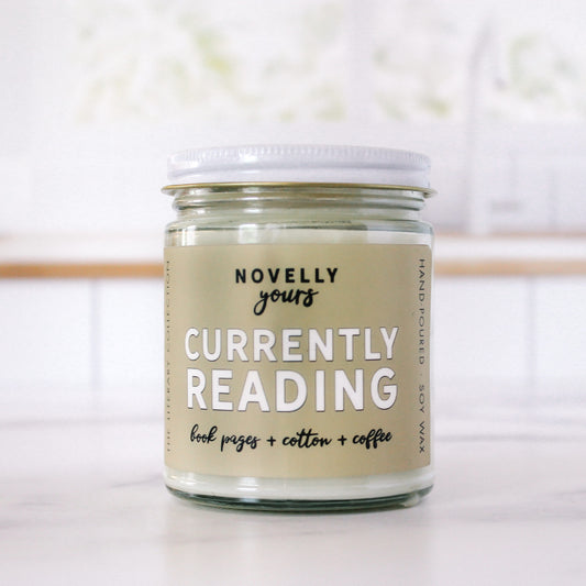 Bookish candle labeled “Currently Reading”—a fun accessory for book lovers, ideal for relaxing with a good book or gifting to readers.
