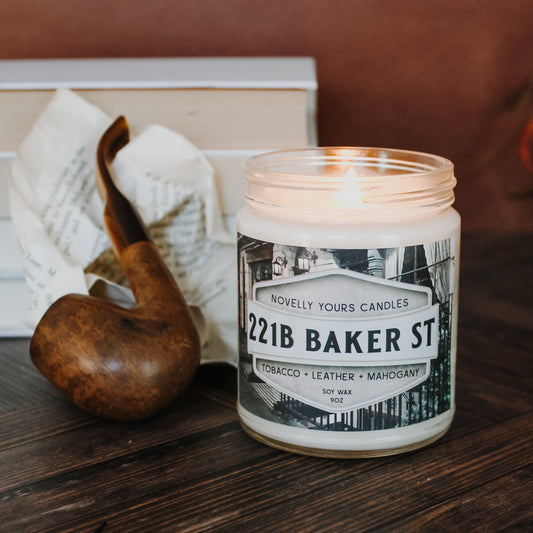Sherlock Holmes inspired candle 221B Baker St - view of the London townhome on the label - front view with leather background and a pipe next to the candle for decoration