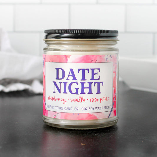 date night soy wax scented candle in clear glass jar with black lid, purple and pink label