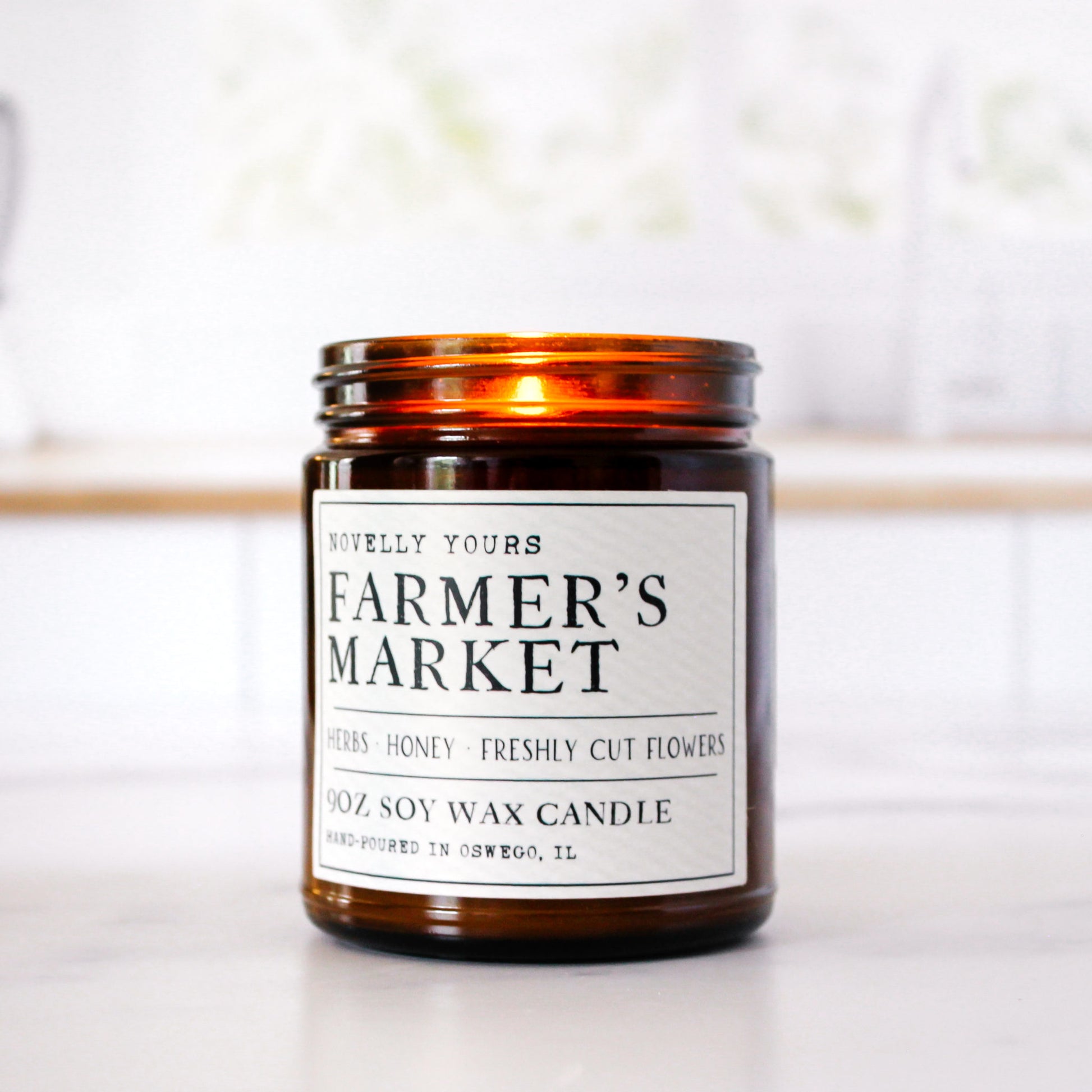 soy wax candle in amber jar called "Farmer's market" with rustic label aesthetic