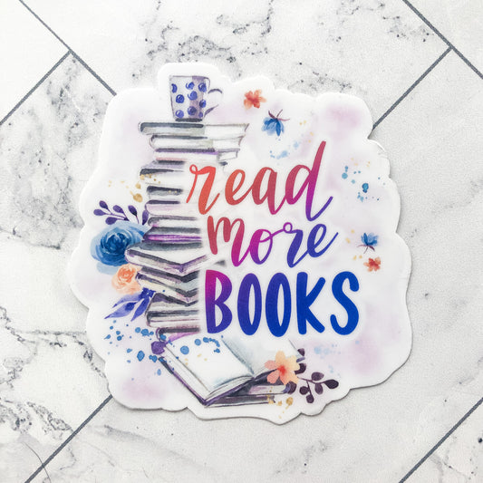 watercolor design with stack of books and text "read more books" in red, purple, and pink