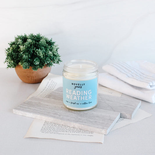 Reading weather bookish scented candle with light blue label 