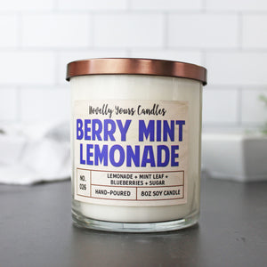 soy wax candle scented like lemonade and blueberry in clear jar with bronze lid