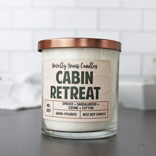 cabin retreat soy wax candle in glass jar with bronze lid