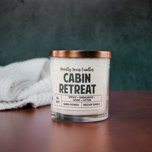 cabin retreat soy wax candle in glass jar with bronze lid
