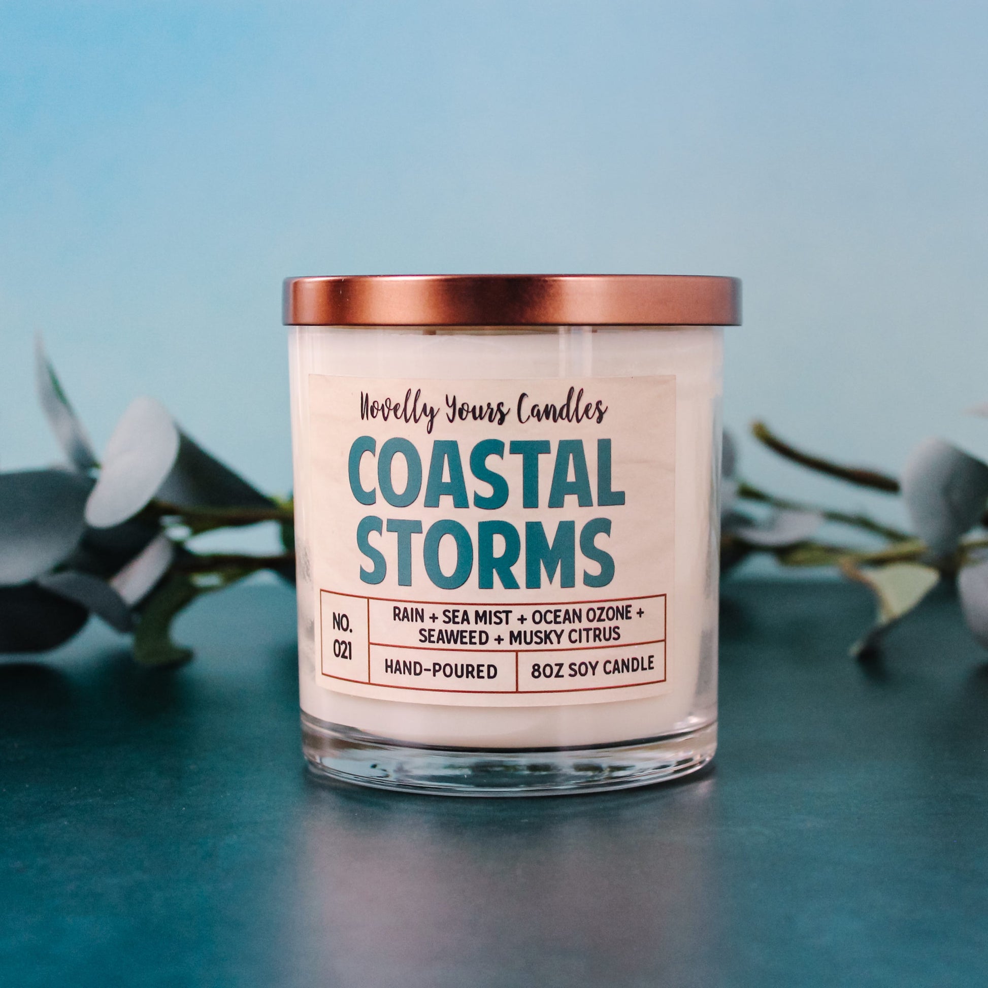coastal storms ocean scented candle in clear glass tumbler jar with bronze lid and two cotton wicks made by novelly yours