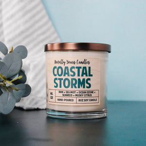 coastal storms ocean scented candle in clear glass tumbler jar with bronze lid and two cotton wicks made by novelly yours