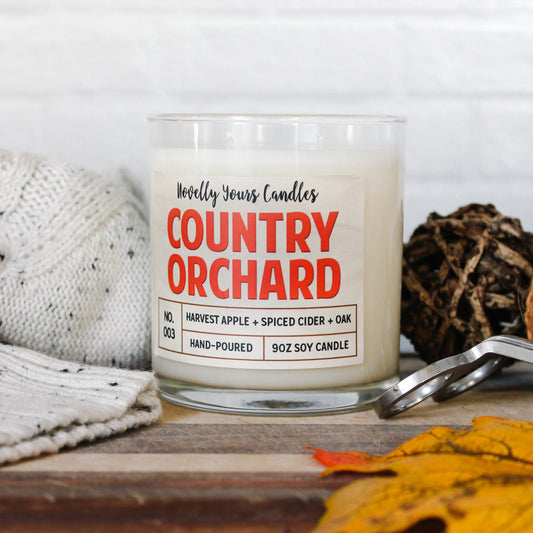 country orchard candle fall seasonal, in glass tumbler jar surrounded by fall decor