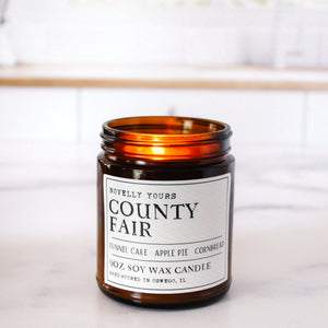 county fair bakery scented soy wax candle in amber jar sits against clean kitchen background