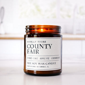 county fair bakery scented soy wax candle in amber jar sits against clean kitchen background