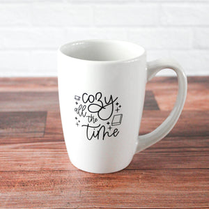 white mug with black script text reading 