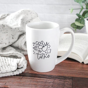 white mug with black script text reading 