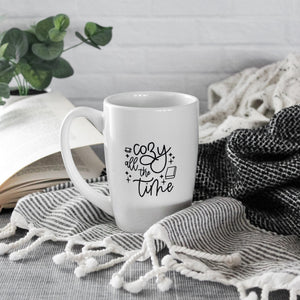 white mug with black script text reading 