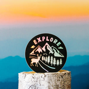 black and rainbow holographic sticker with outdoors and forest scenery with text 