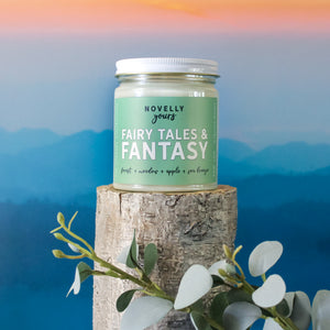 fairy tales & fantasy bookish candle with a green label and clear glass jar