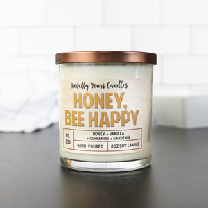 honey bee happy candle in gold honey colored text, candle in glass tumbler jar with bronze lid