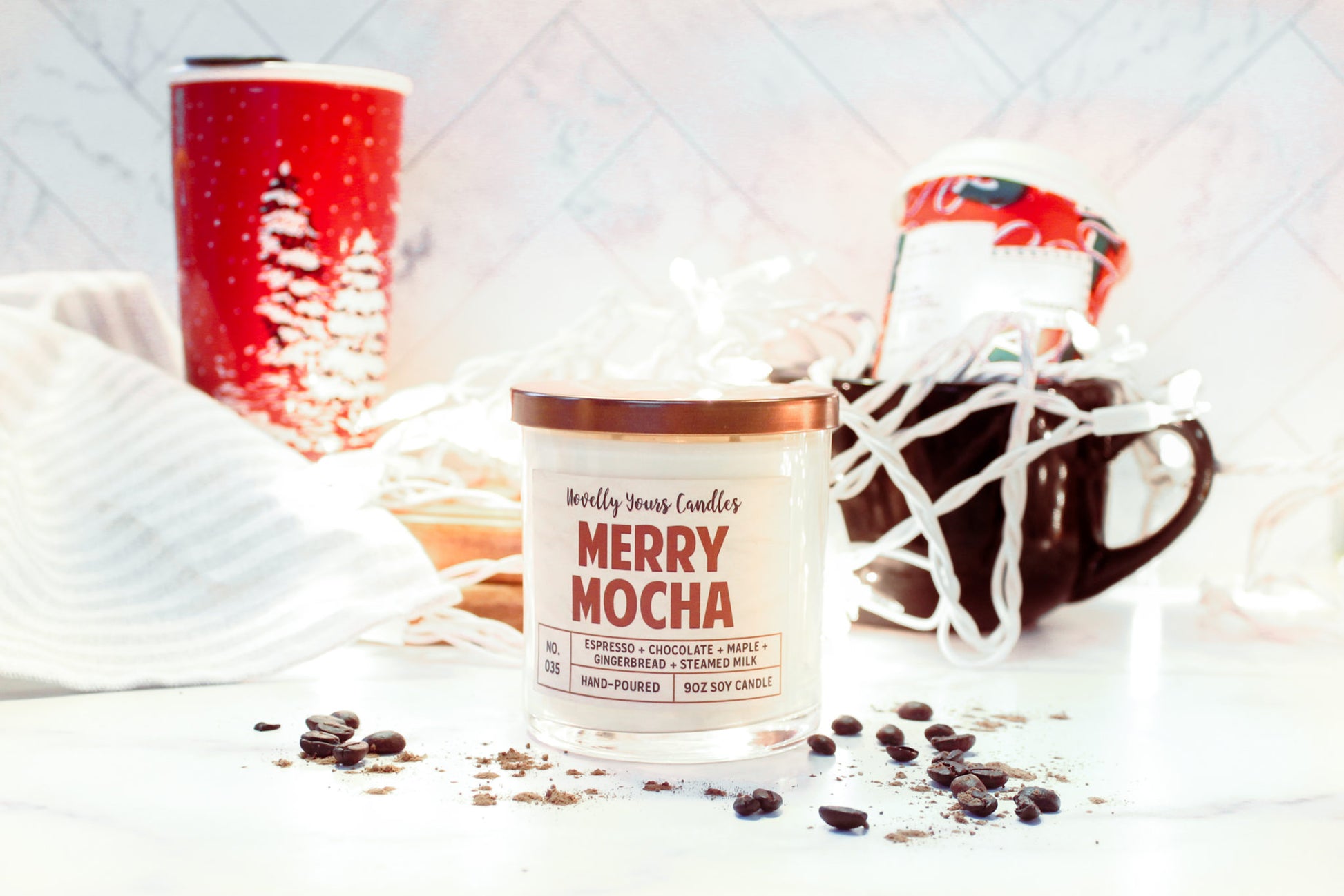 merry mocha scented soy wax candle in clear glass tumbler with bronze lid in rusty red text