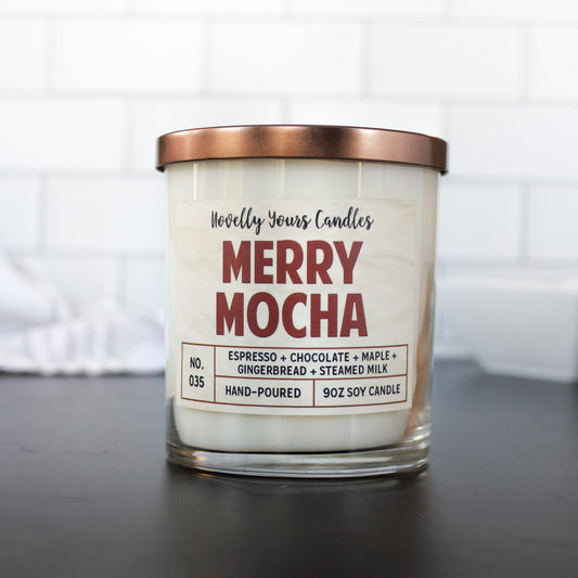 merry mocha scented soy wax candle in clear glass tumbler with bronze lid in rusty red text