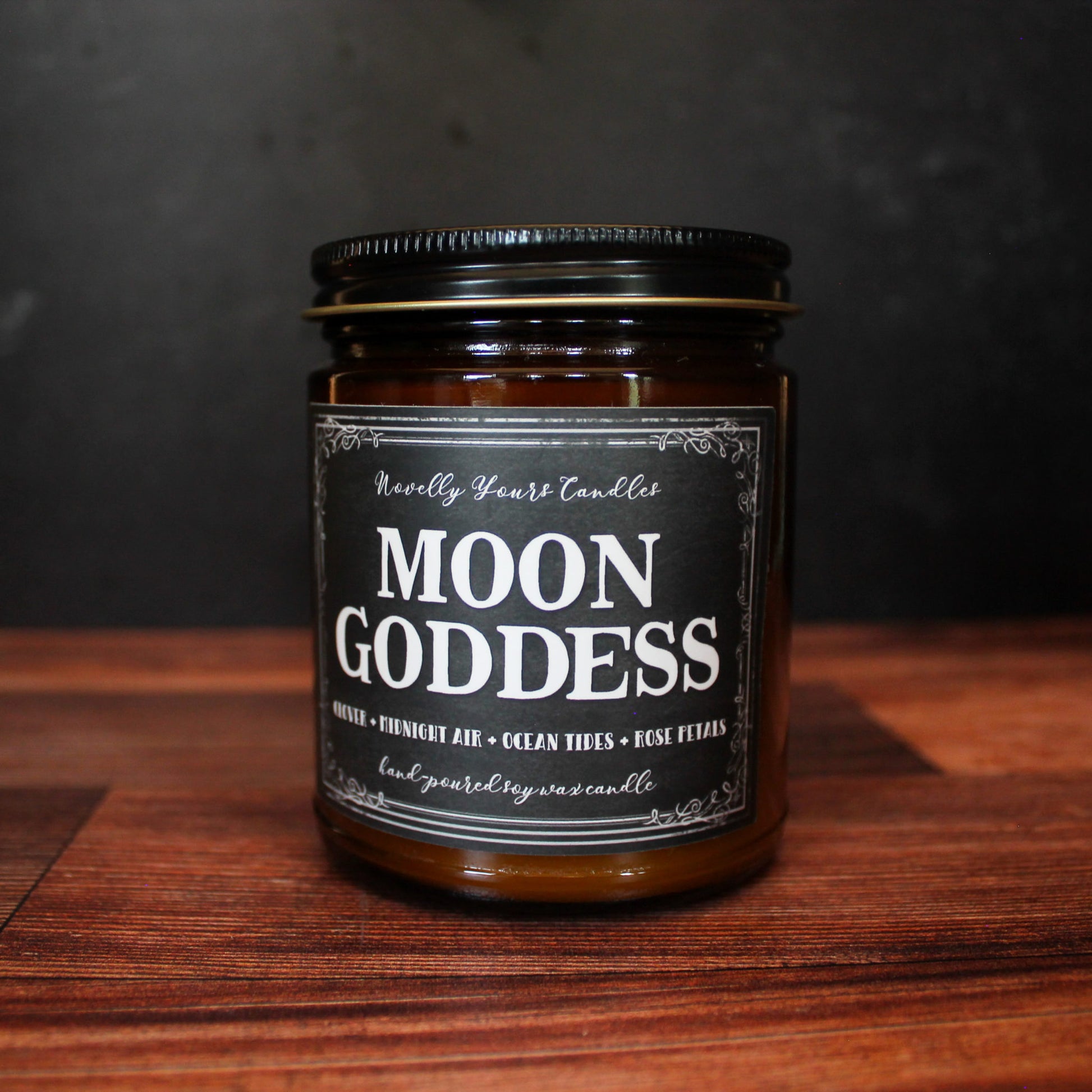 moon goddess scented soy wax candle in amber glass jar, with black lid
