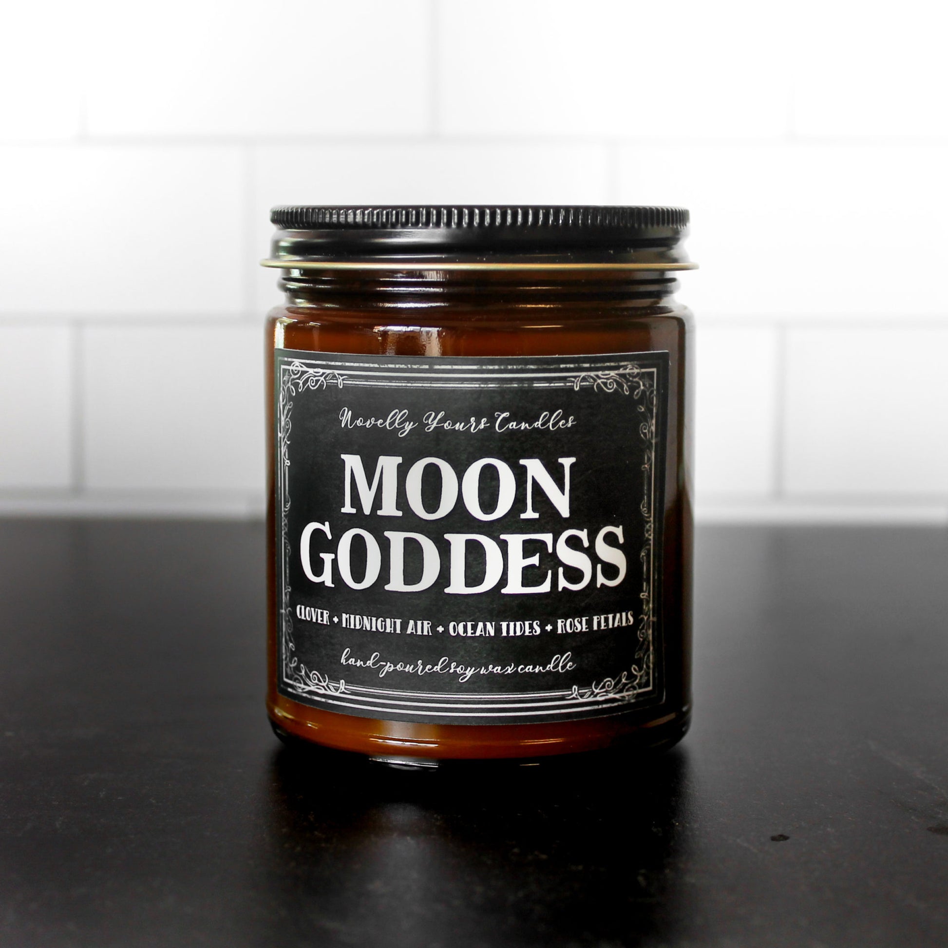 moon goddess scented soy wax candle in amber glass jar with black lid