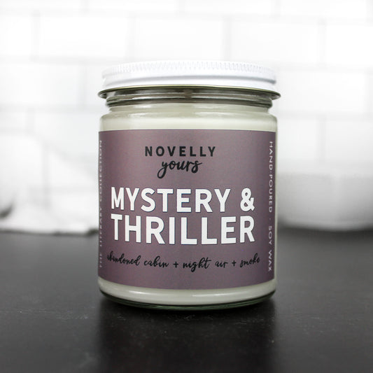 mystery & thriller scented soy wax candle with purple grey label and white metal lid