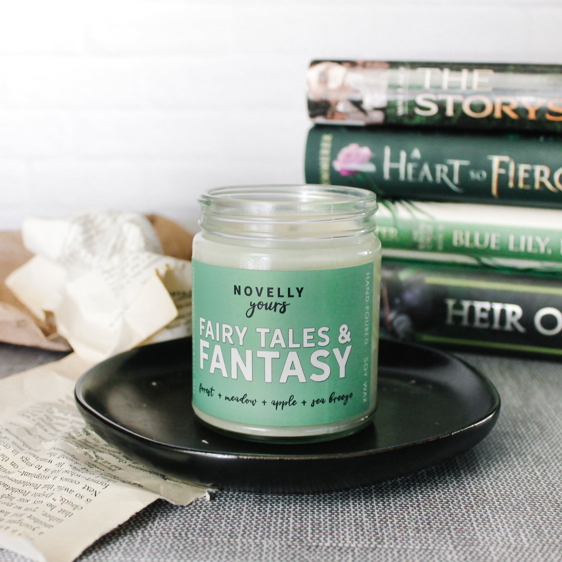 fairy tales & fantasy bookish candle with a green label and clear glass jar