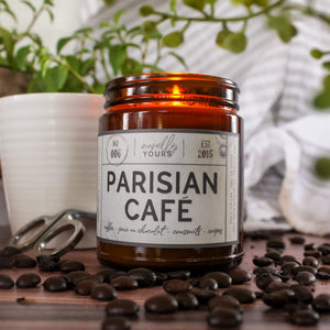 scented soy wax candle in amber jar, lit, surrounded by coffee beans reading 