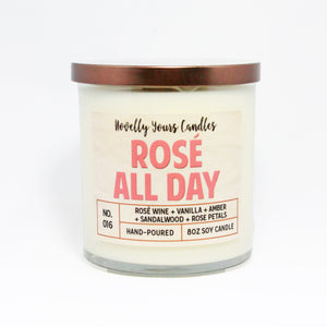 Rosé All Day scented soy wax candle in glass tumbler jar with bronze lid and pink label lettering