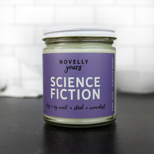 science fiction scented soy wax candle in clear glass jar with white lid and purple label