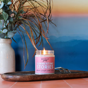 summertime stories summer book themed candle with pink label and fruity scents