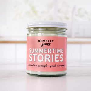 summertime stories summer book themed candle with pink label and fruity scents
